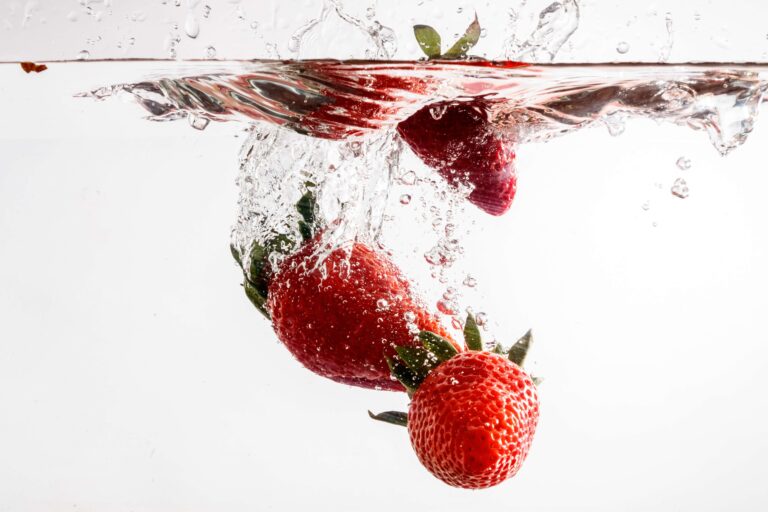 strawberries dropping into water